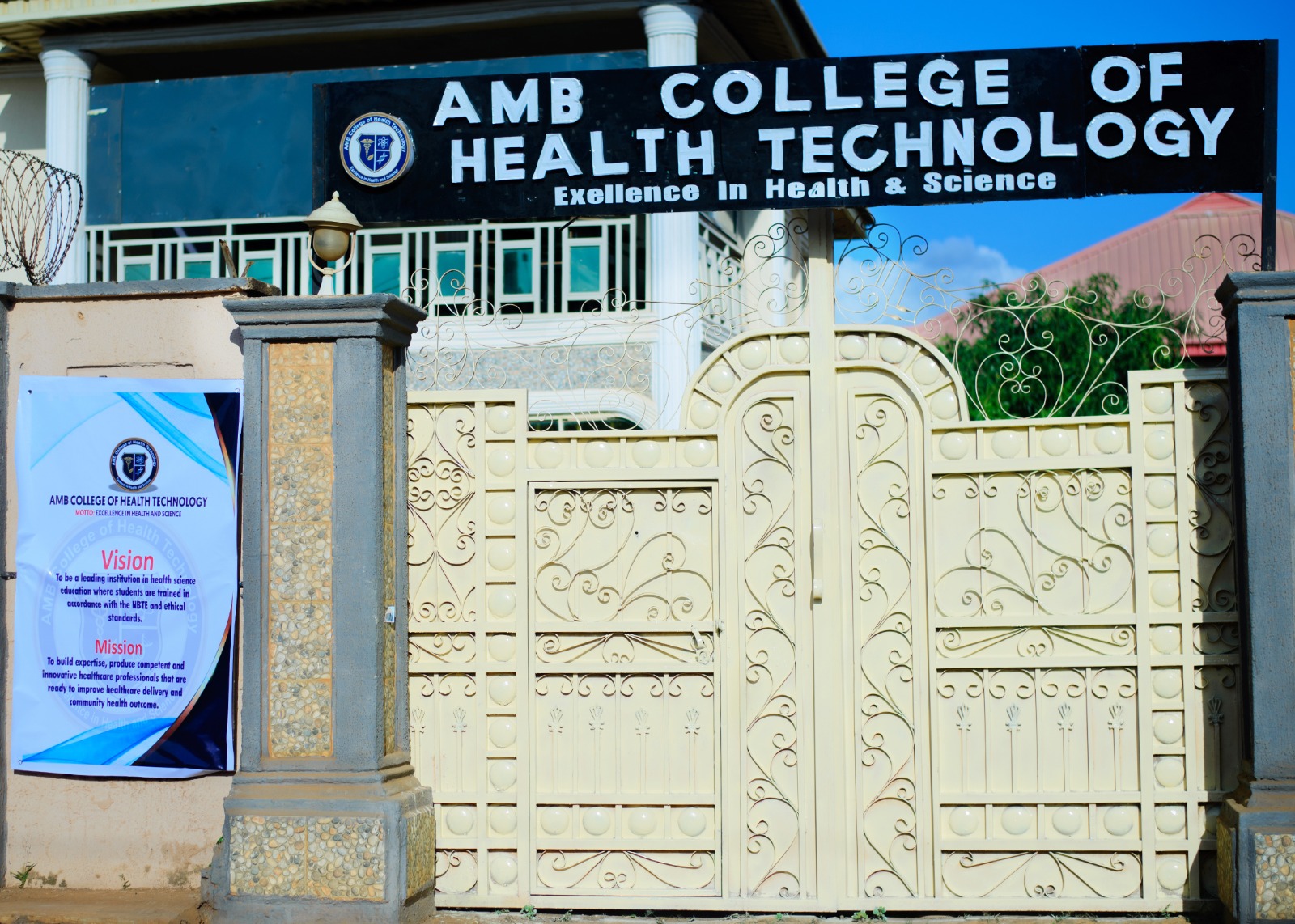 Signage at AMB College of Health Technology showing the college motto, vision and mission