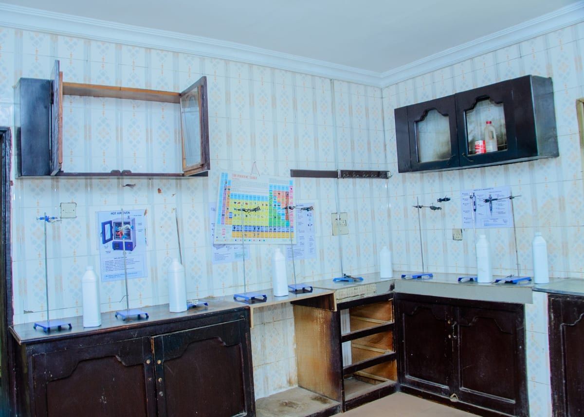 The science laboratory used for Pharmacy Technician practicals, with retort stands and reagent bottles